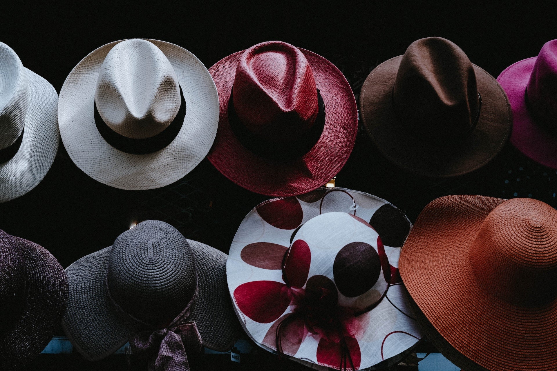 Range of colourful straw hats of varying styles
