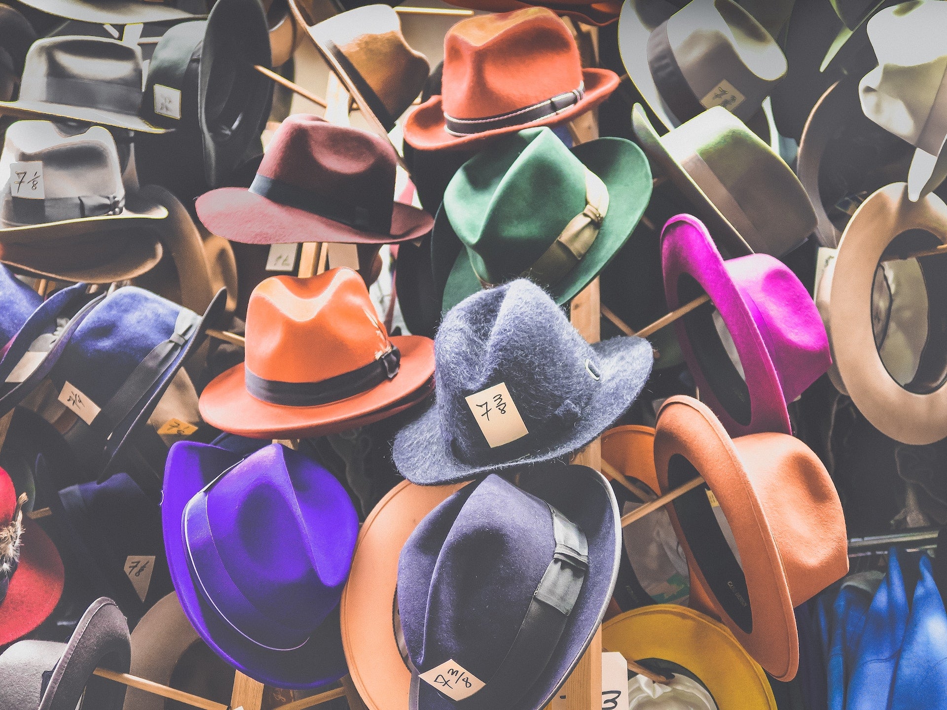 Multi-coloured wool felt hats on a hat stand