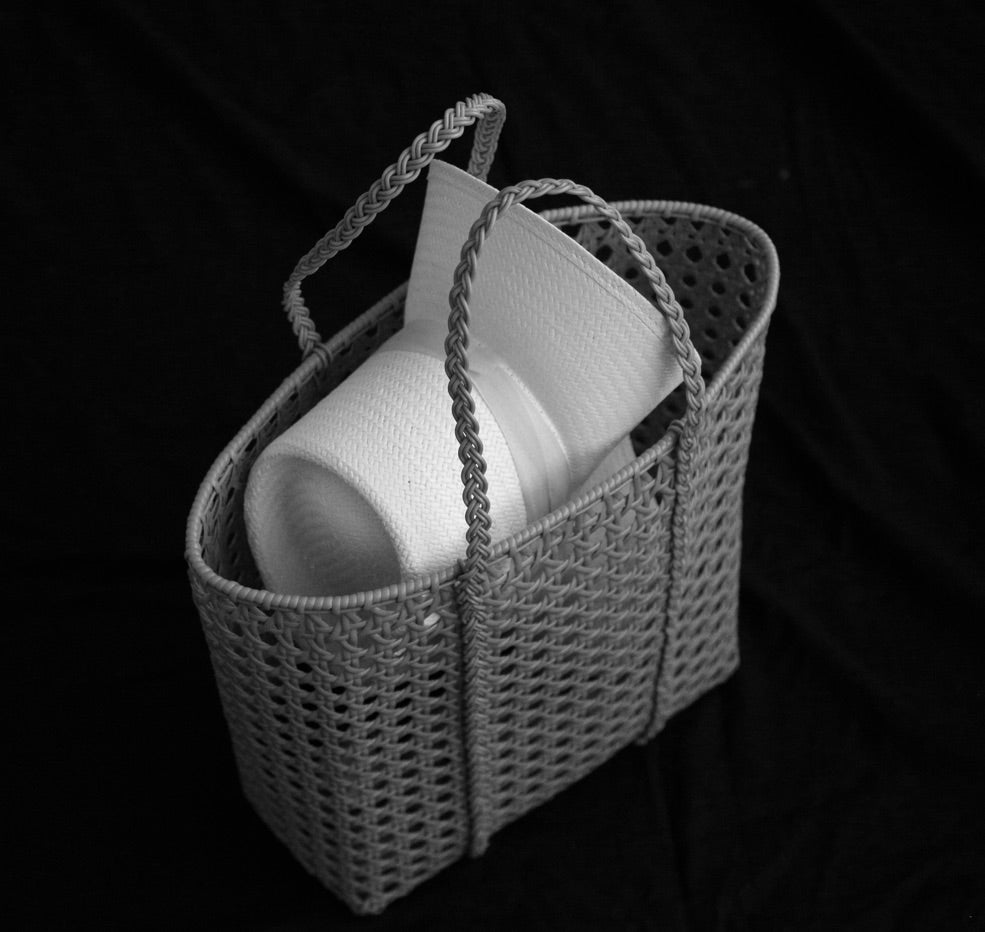 Elevated collection sandstone designer hat packed in a straw carry bag 
