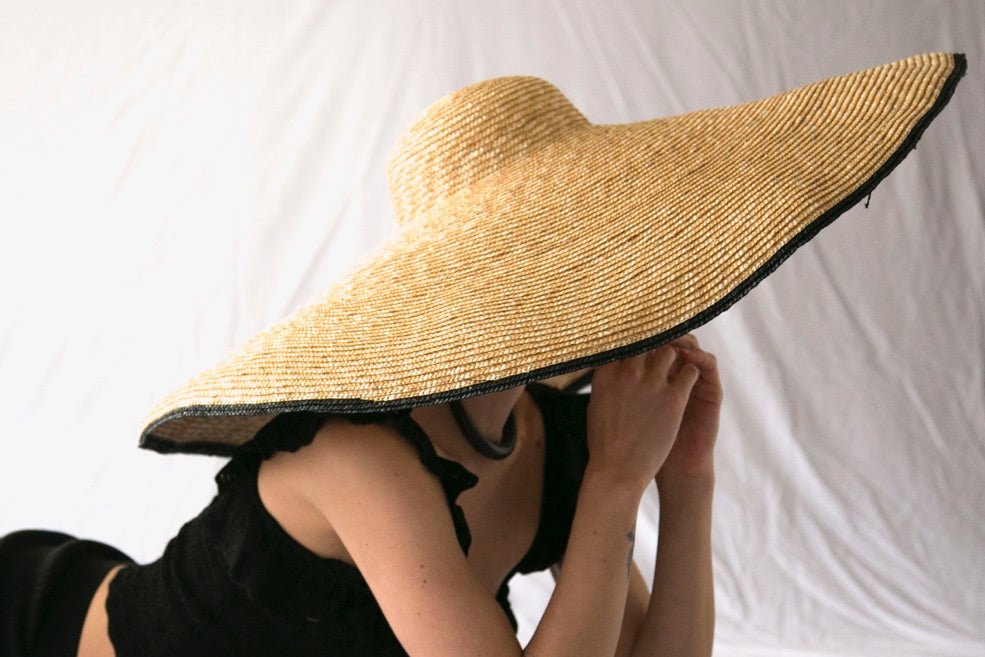 Straw hat with very large brim with black rim  