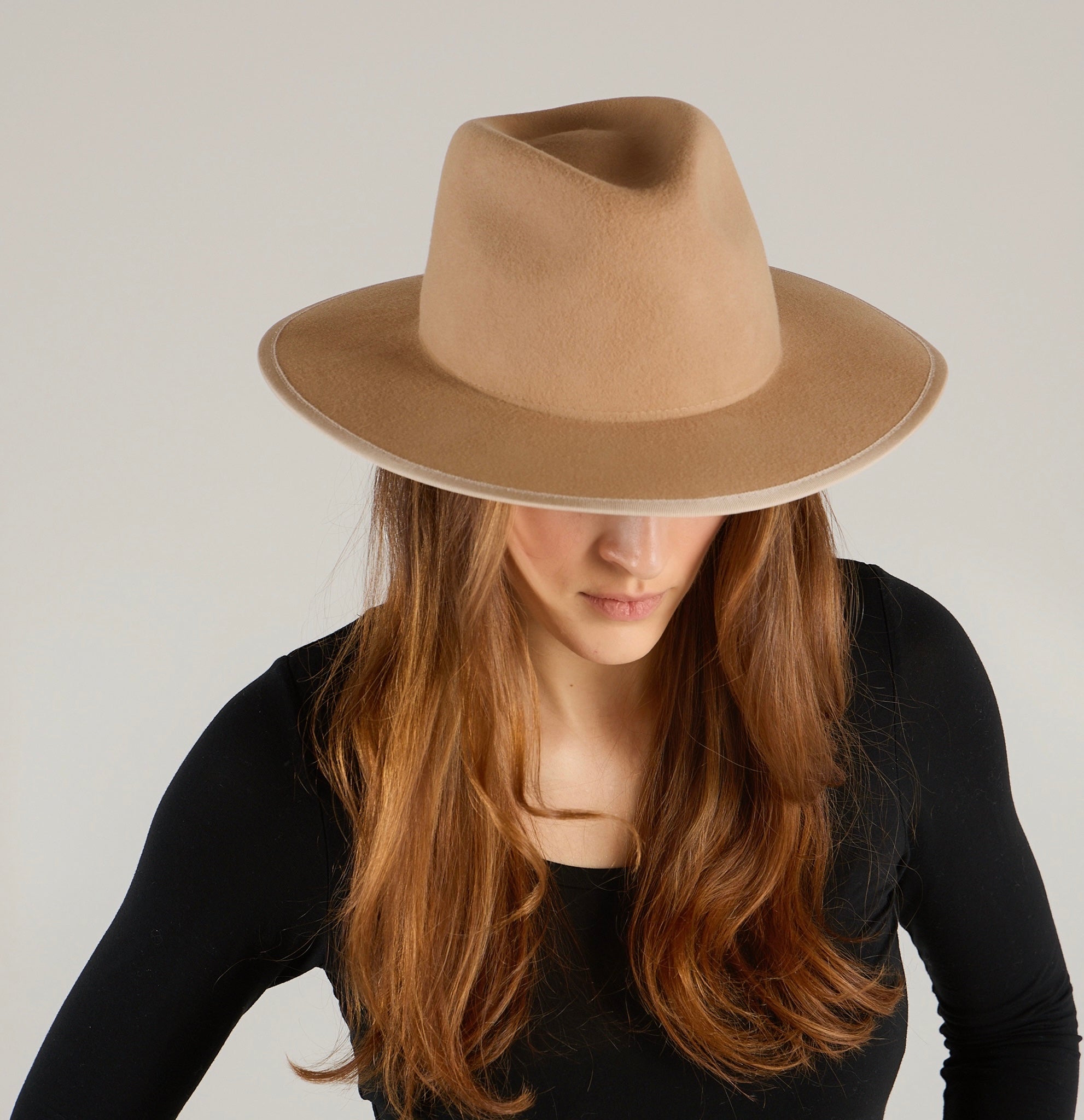Women wearing a camel shade wool felt hat